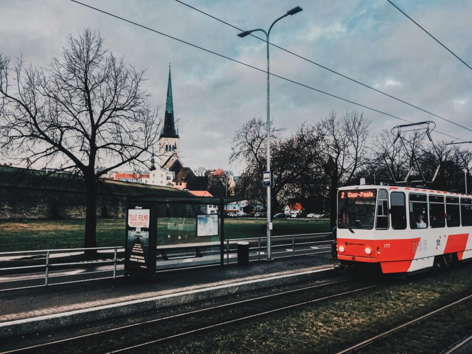 A scenic view of a tram passing by St. Olaf's Church in Tallinn, Estonia.